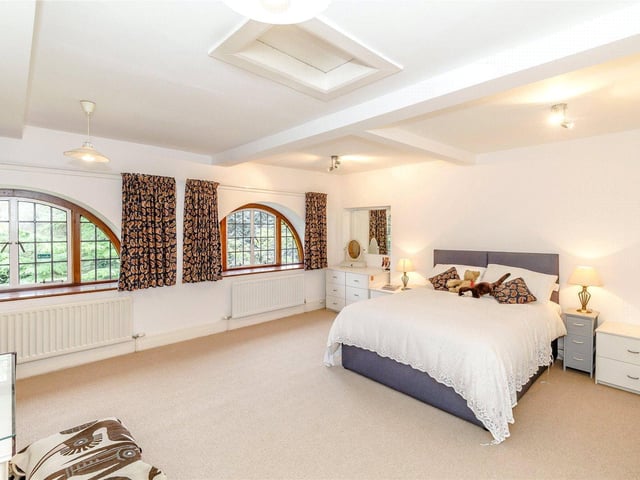 There are four bedrooms in total, including this large master room which boasts patio doors that lead out onto a private roof terrace.