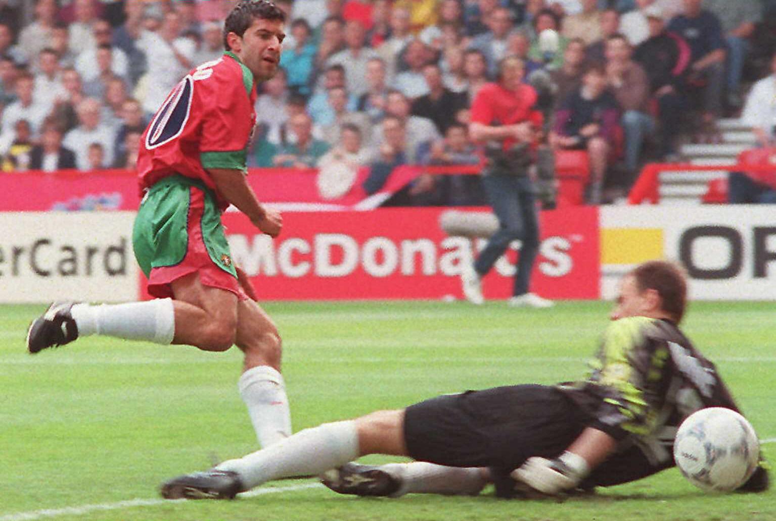 Portugal's Luis Figo beats the Croatian goalkeeper to give his team a 1-0 lead against already-qualified Croatia.