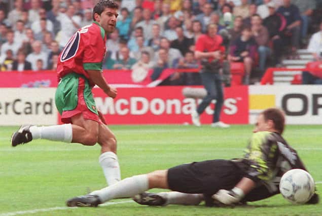 Portugal's Luis Figo beats the Croatian goalkeeper to give his team a 1-0 lead against already-qualified Croatia.