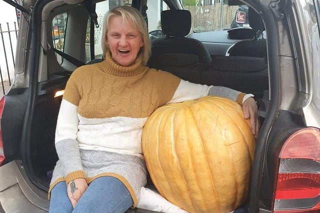 Natalie Pinky Parkes' mum with just one of the pumpkins from Natalie's allotment. It weighed 12 stone and took two men, a ramp and a wheelbarrow to shift.