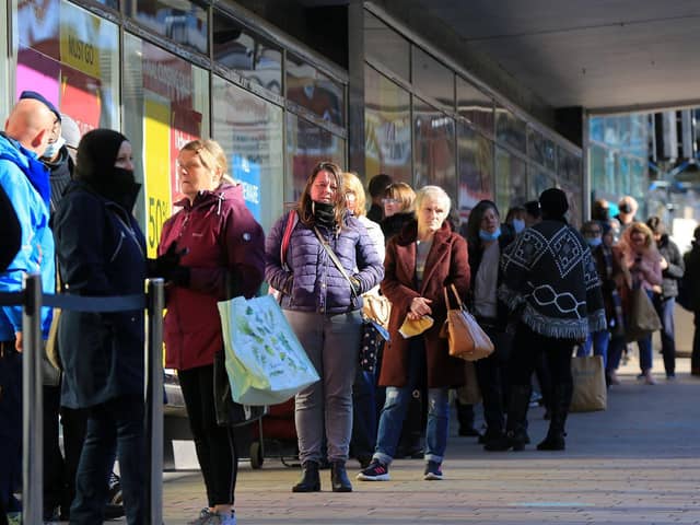 Shoppers queue for a bargain at Debenhams on The Moor.