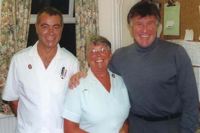 Footballer Emlyn Hughes with St Luke's Hospice staff