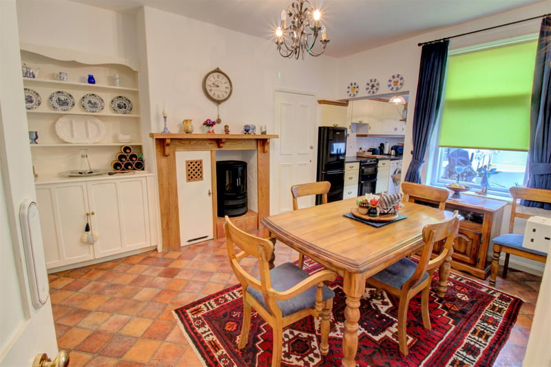 Plenty of space is available within the dining end of the room to place a table and chairs and an electric effect wood burner stood within a little inglenook adds to the pretty farmhouse cottage feel of the whole room.