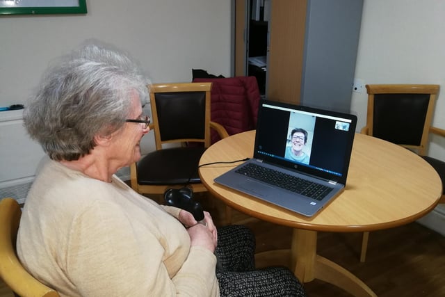 A resident at Norton Lees Hall and Lodge Care Home in Sheffield can be seen using the Skype facility to chat with her daughter.