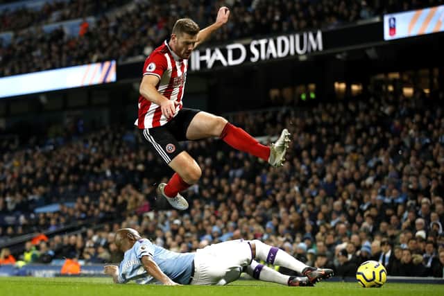 Sheffield United's Jack O'Connell (left) and Manchester City's Fernandinho battle for the ball during theis season's Premier League match at The Etihad Stadium: Martin Rickett/PA Wire.