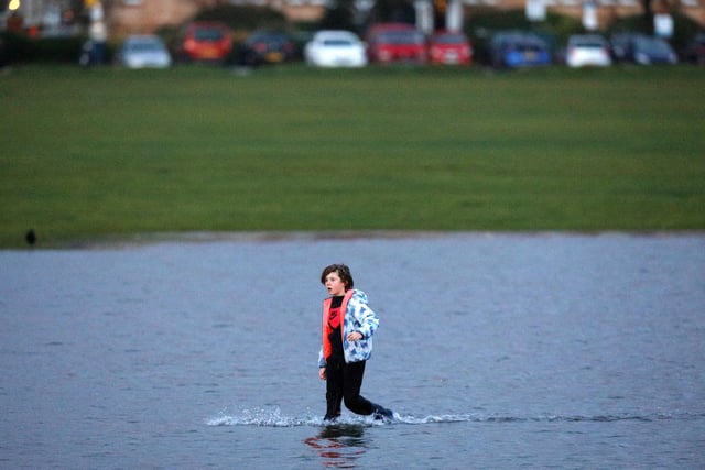 A boy paddles on Southsea Common as it was flooded during Storm Barra. Picture: Chris Moorhouse  (jpns 071221-17)