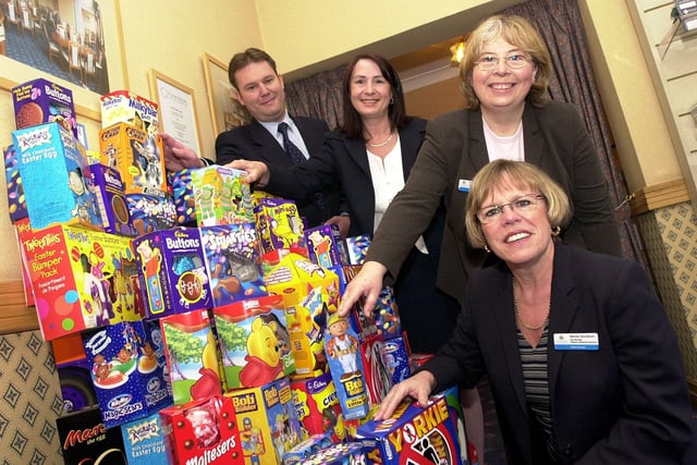In 2003 Doncaster Funeralcare manger Shaun Varley handed over the Easter Eggs to DMBC Social Services Children's Residential Resources team managers Wendy Needham (front) and Angela Mackenzie (third left) and Julie Wybrant, deputy manager St Wilfrid's Child Care Unit, in Cantley.