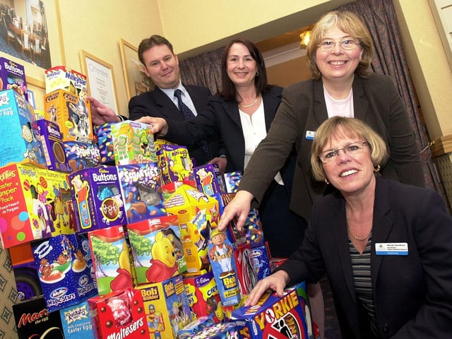 In 2003 Doncaster Funeralcare manger Shaun Varley handed over the Easter Eggs to DMBC Social Services Children's Residential Resources team managers Wendy Needham (front) and Angela Mackenzie (third left) and Julie Wybrant, deputy manager St Wilfrid's Child Care Unit, in Cantley.