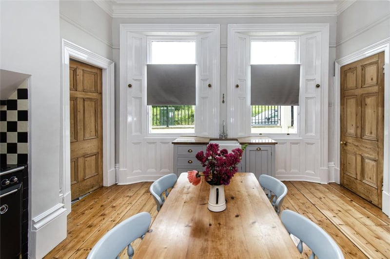 Two single-glazed sash windows with panelling to either side looking to front aspect.