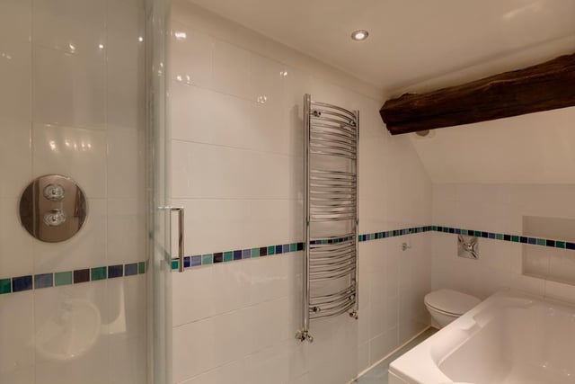 The family bathroom contains a panelled tub and a separate shower enclosure.