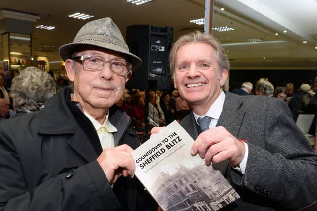 Neil Anderson at the launch of the Sheffield Blitz Trail App, held at Atkinson's department store, signing a copy of his second book on the Sheffield Blitz for Terence Linfoot