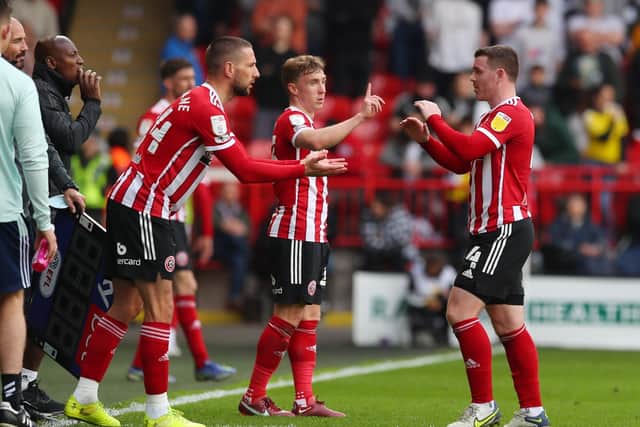 Sheffield United midfielders John Fleck (right) and Ben Osborn (centre) both feature in Paul Heckingbottom's plans for next term: Simon Bellis / Sportimage
