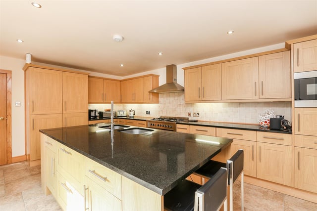 The house has a bespoke kitchen with solid granite worktops and integrated appliances.