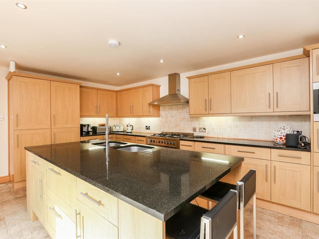 The house has a bespoke kitchen with solid granite worktops and integrated appliances.