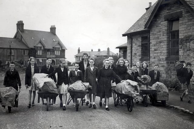 An old picture of children from Lydgate Lane School pictured with wheelbarrows, but what is in the barrows?  Stephen Hill Church is on the right and  the Sportsman Pub centre left in the background