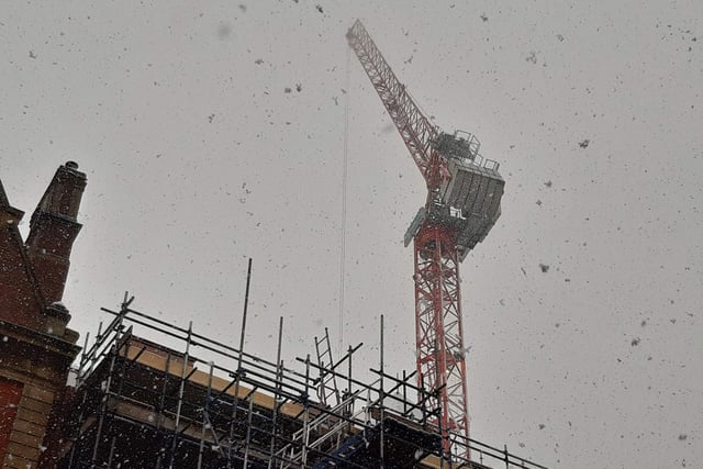 The crane on the Radisson Blu hotel site on Pinstone Street was partially obscured by snowflakes.