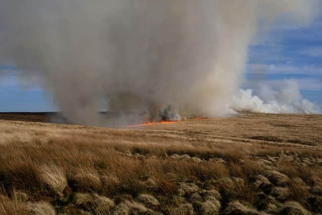 TOPSHOT - A fire burns out of control on moorland above the village of Marsden in northern England, on March 23, 2020. (Photo by OLI SCARFF / AFP) (Photo by OLI SCARFF/AFP via Getty Images)