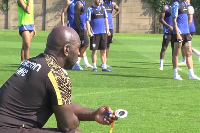 Darren Moore oversees training drills at Sheffield Wednesday's Middlewood Road training ground.