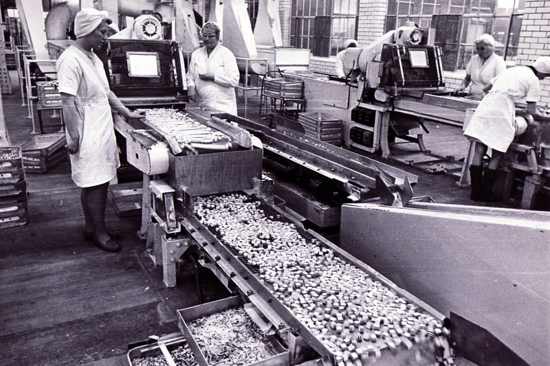 Liquorice allsort cubes come along the conveyor belt for sorting in February 1972
