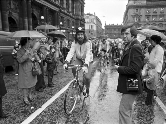 Scottish entertainer Billy Connolly leaves Glasgow on a sponsored cycle ride to Inverness in August 1980. Billy sets off from a rain-soaked George Square.