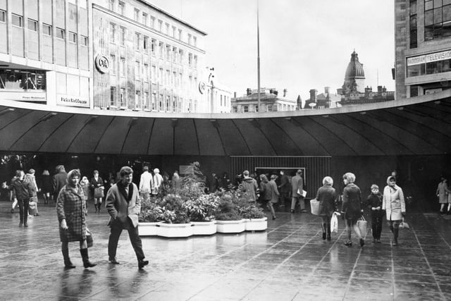 A view inside the Hole in the Road in the 1970s with flower beds and the famous fish tank seen in the background