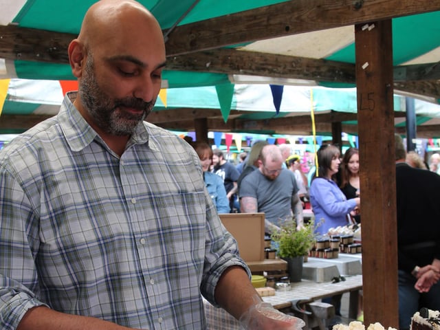 Aaron Budon cut a slice of vegan rainbow cake in 2019