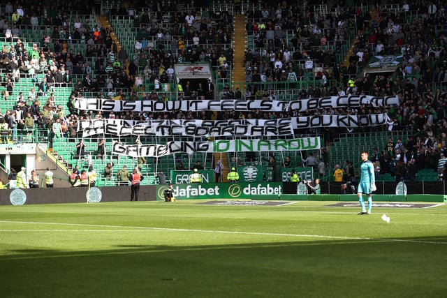 Celtic fans display a banner reading: "This is how it feels to be Celtic, downsizing again as you know, the Celtic board are gambling 10 in a row" at a Betfred Cup match with Dunfermline in August 2019