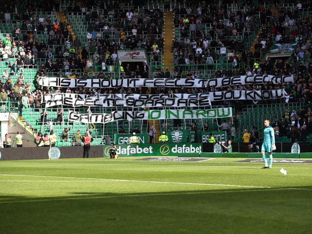 Celtic fans display a banner reading: "This is how it feels to be Celtic, downsizing again as you know, the Celtic board are gambling 10 in a row" at a Betfred Cup match with Dunfermline in August 2019