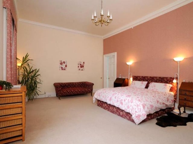 The master bedroom is generous in size and boasts its own en-suite bathroom and dressing room.
