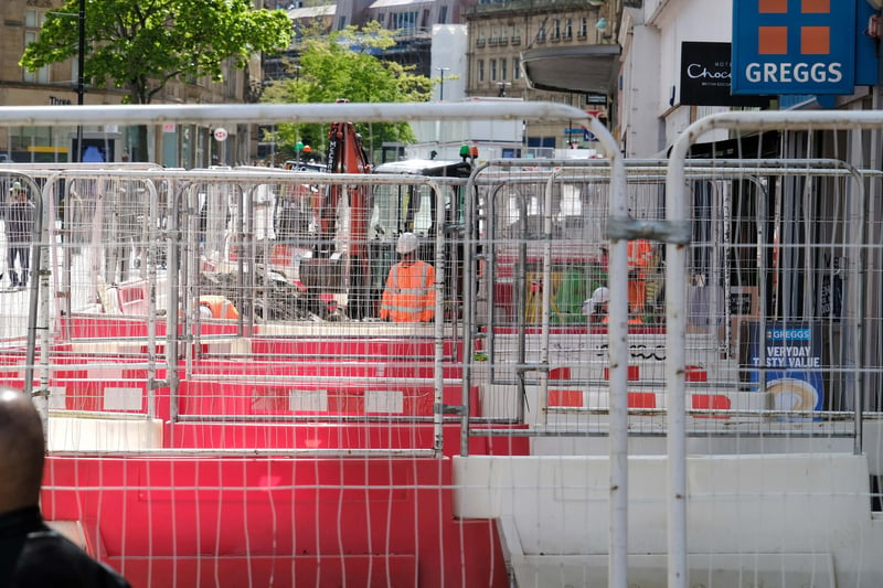 Red and white barriers and metal fencing on Fargate in May 2023.