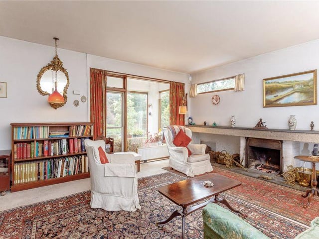 The living room benefits from large windows and an open fire
