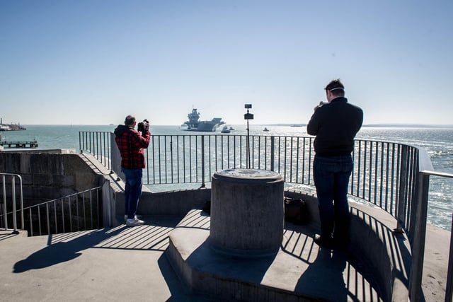 Reporter Davvid George (right) filming HMS Prince of Wales from the Round Tower, Old Portsmouth.