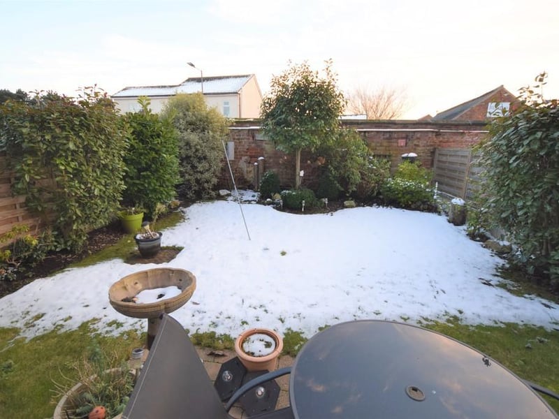 Rear garden provides a lovely setting having a patio ideal for seating and entertaining in the summer months which flows onto a lawned garden with well-established shrubs to the borders, fenced and walled boundaries.