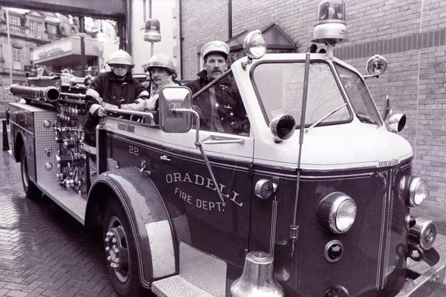 On the Beaujolais trail to France is this fire engine from the USA in Orchard Square, Sheffield. Pictured left to right are firemen Ian Short, Stuart Hobson and Tony Hunter, October 7, 1989