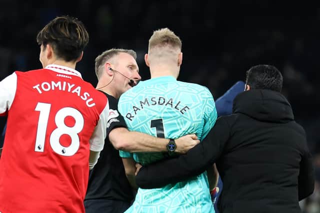 Mikel Arteta walks Aaron Ramsdale towards the Arsenal fans to celebrate victory over Tottenham Hotspur after appearing to be kicked by a Spurs fan (Catherine Ivill/Getty Images)