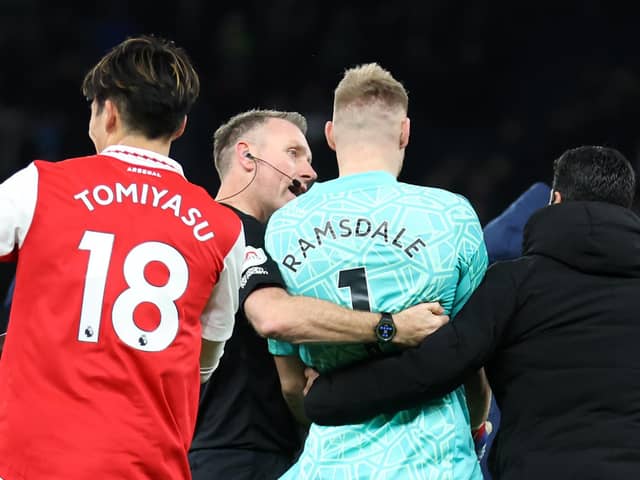 Mikel Arteta walks Aaron Ramsdale towards the Arsenal fans to celebrate victory over Tottenham Hotspur after appearing to be kicked by a Spurs fan (Catherine Ivill/Getty Images)