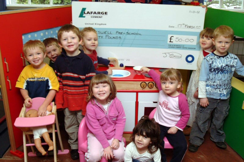 Children at Tideswell Playgroup receive a donation for their new kitchen from Lafarge Cement in 2005.