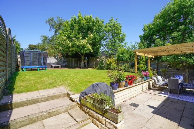 Landscaped garden with patio, pergola & play area with summer house.