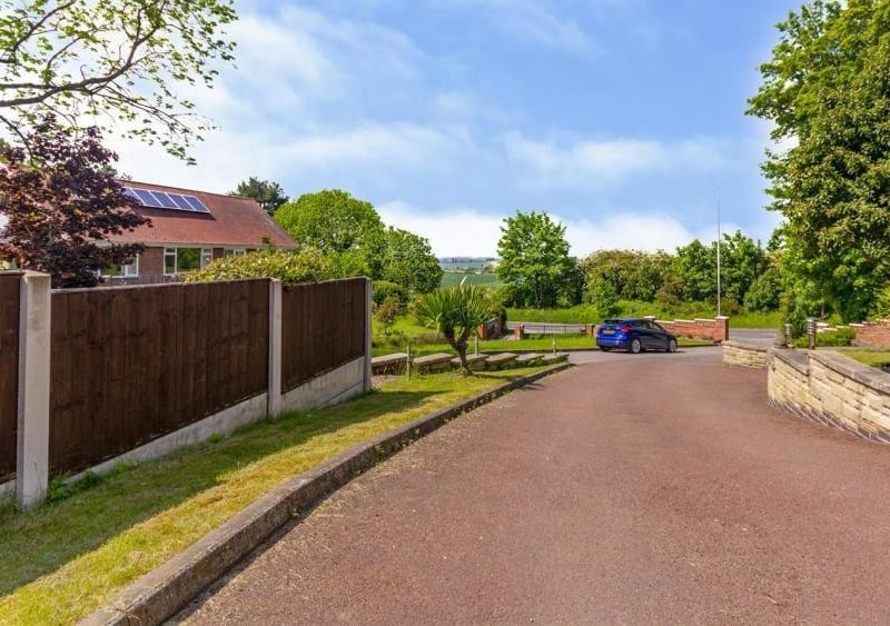 The winding driveway that leads to what could be your dream home. It also leads to beautifully landscaped gardens, a maintained lawn, a double garage and off-street parking for lots of vehicles.