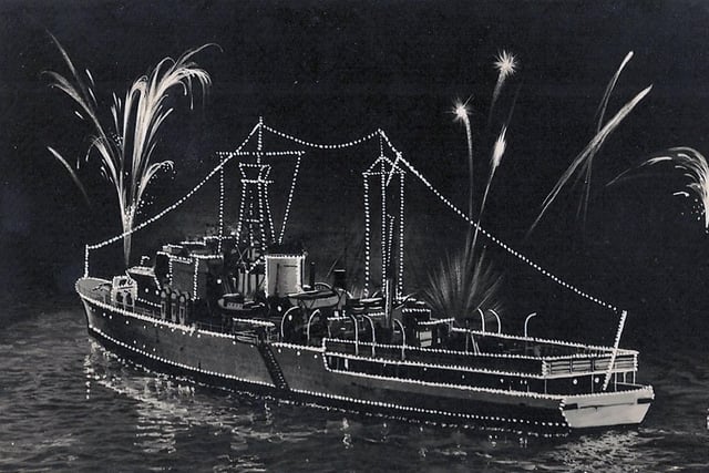 The fleet lit up for the Coronation fleet review at Spithead in 1953. Royal Navy's Royal Yacht HMS Surprise.