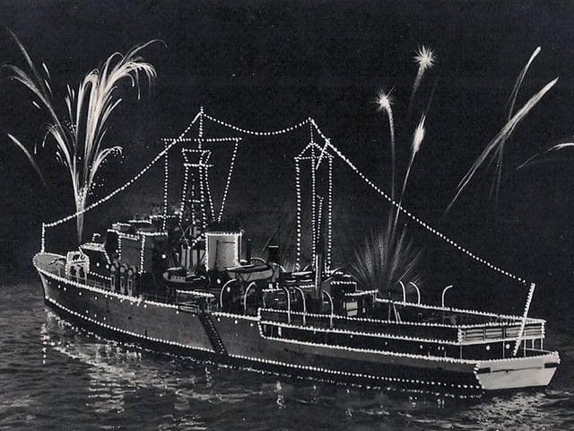 The fleet lit up for the Coronation fleet review at Spithead in 1953. Royal Navy's Royal Yacht HMS Surprise.