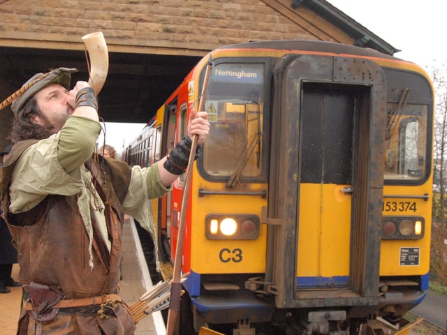 Trains began running on Sundays from Mansfield station in December 2008 - the town previously had the unenviable reputation of being the largest in the UK not to have Sunday rail services. 'Robin Hood' is pictured signalling the departure of the first train to leave on the Robin Hood Line to Nottingham.
