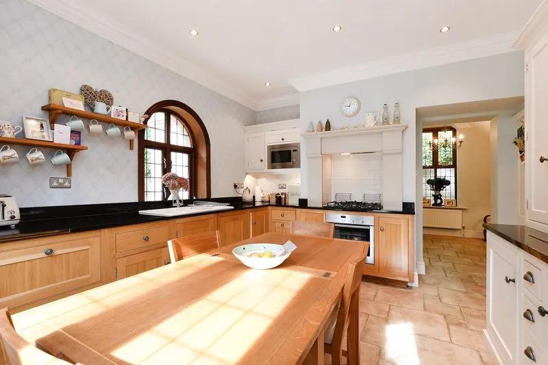 The kitchen has a range of fitted units, finished granite worktops and matching splash-backs. Included in the sale is an integrated oven with a gas hob and an extractor above, a microwave oven, dishwasher, fridge and a separate freezer.