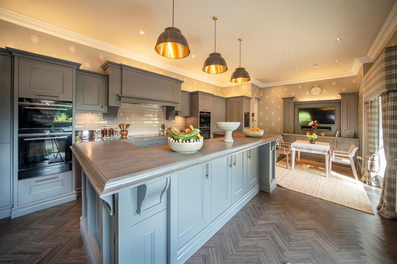 The Callerton kitchen and utility room features a raised breakfast bar, butler's pantry, walk-in pantry, Corian Lava Rock worktops, Axix Corian sink, and Siemens appliances including a 92 bottle dual zone wine cabinet.