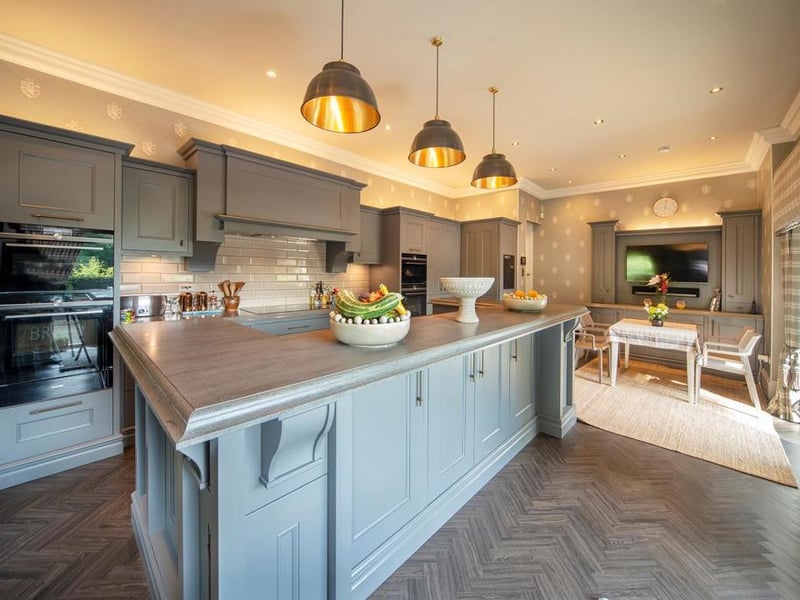 The Callerton kitchen and utility room features a raised breakfast bar, butler's pantry, walk-in pantry, Corian Lava Rock worktops, Axix Corian sink, and Siemens appliances including a 92 bottle dual zone wine cabinet.