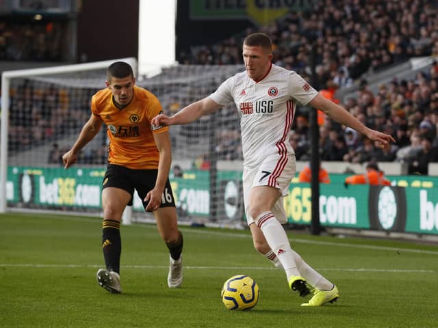 John Lundstram of Sheffield United is marshalled by Conor Coady of Wolverhampton Wanderers during the Premier League match at Molineux, Wolverhampton in December: Simon Bellis/Sportimage