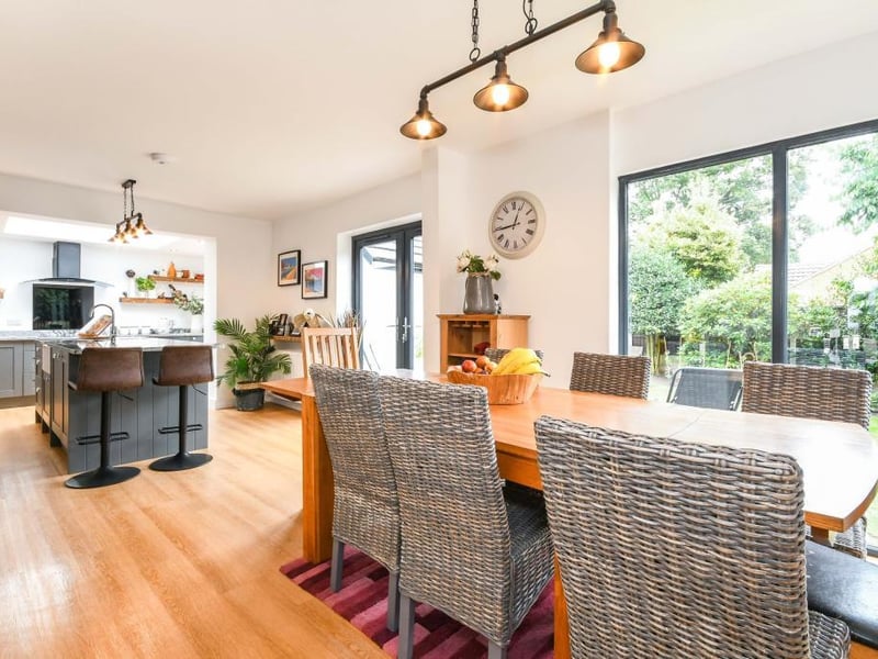 The kitchen has a double-glazed window and French doors looking out to the garden.