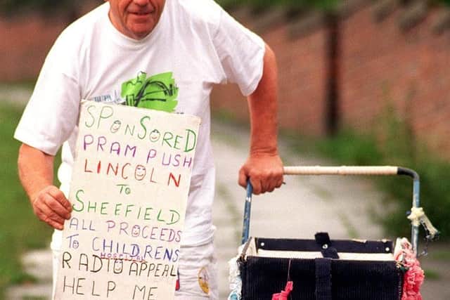 John Burkhill pictured in June 1997 raising money for another good cause when he pushed his pram from Sheffield to Lincoln.
