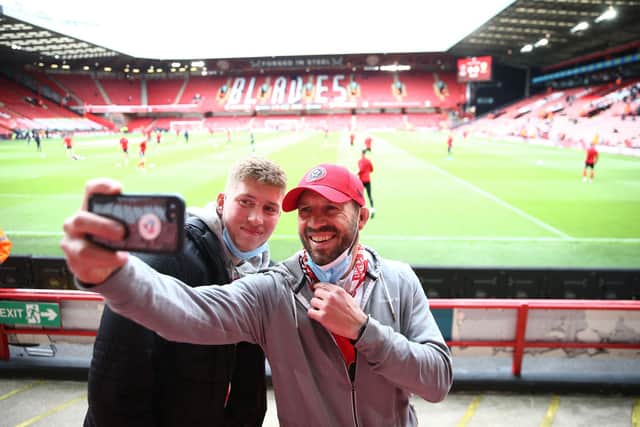 Sheffield United fans pose for a selfie picture ahead of the English Premier League football match between Sheffield United and Burnley at Bramall Lane in Sheffield, northern England on May 23, 2021. (Photo by Jan Kruger / POOL / AFP) / RESTRICTED TO EDITORIAL USE.