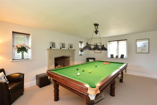 Currently used as a games room, with ample space to house a full-length snooker table, this space could be converted into an additional living room and boasts a central fireplace at its heart.